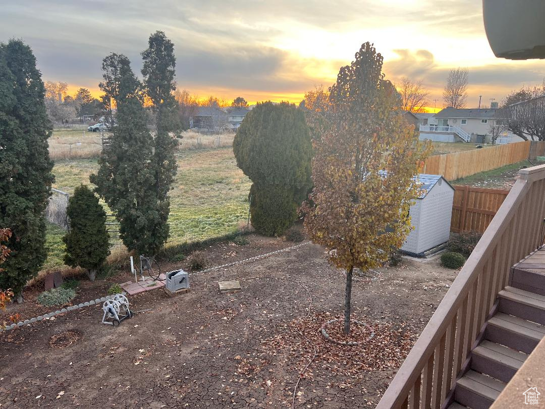 Yard at dusk with a storage shed