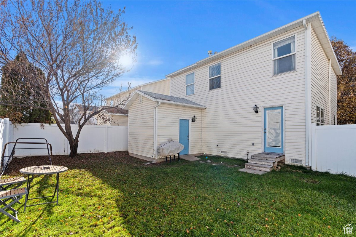 Back of house featuring a lawn