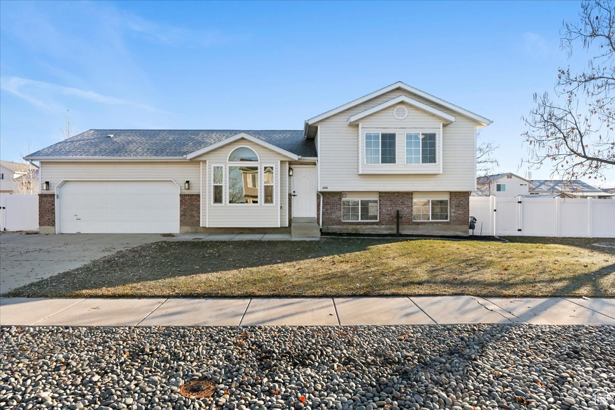 View of front facade with a front yard and a garage