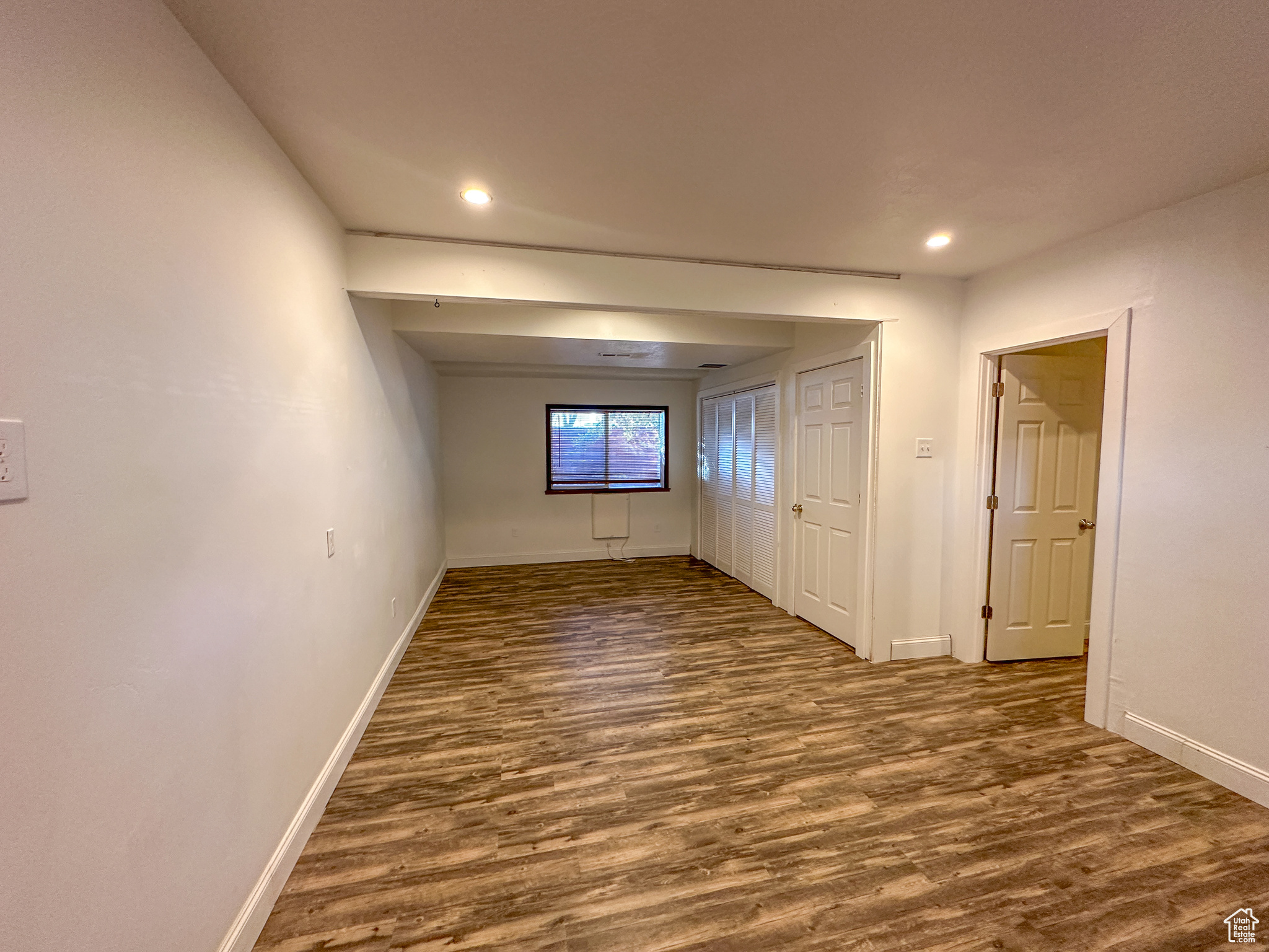 Unfurnished room featuring dark hardwood / wood-style floors