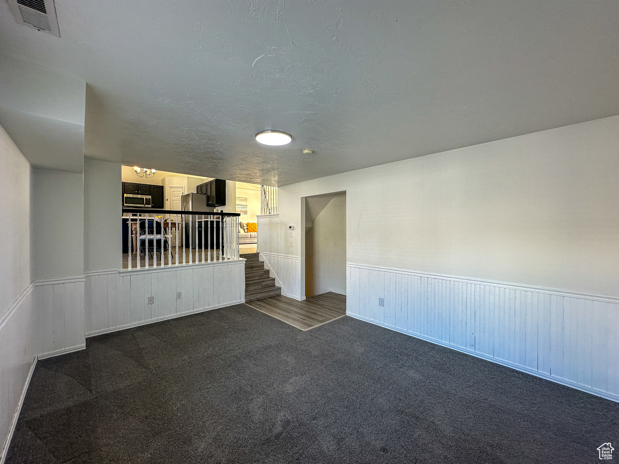 Carpeted spare room with a textured ceiling