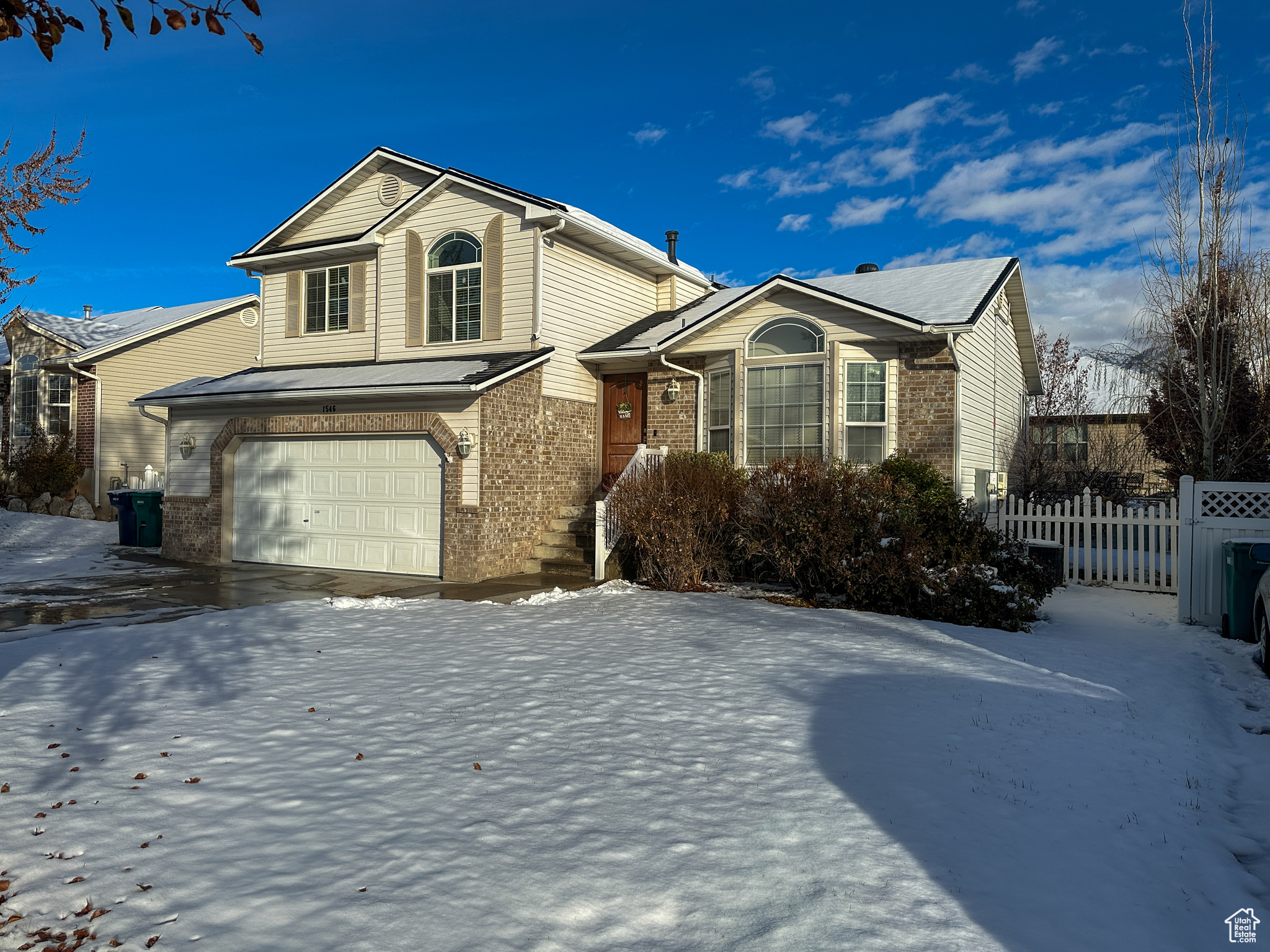 View of front facade featuring a garage