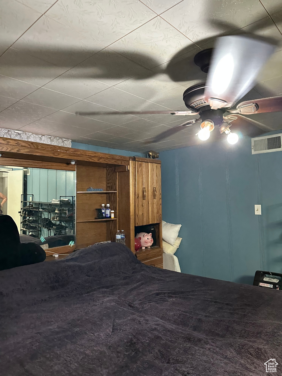 Carpeted bedroom with ceiling fan