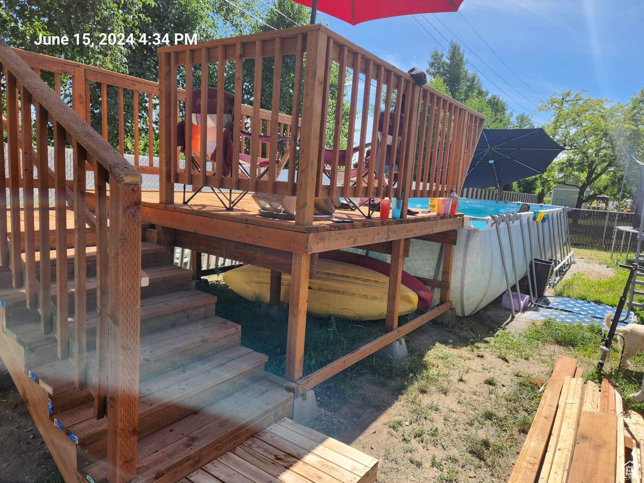 Wooden deck featuring a fenced in pool