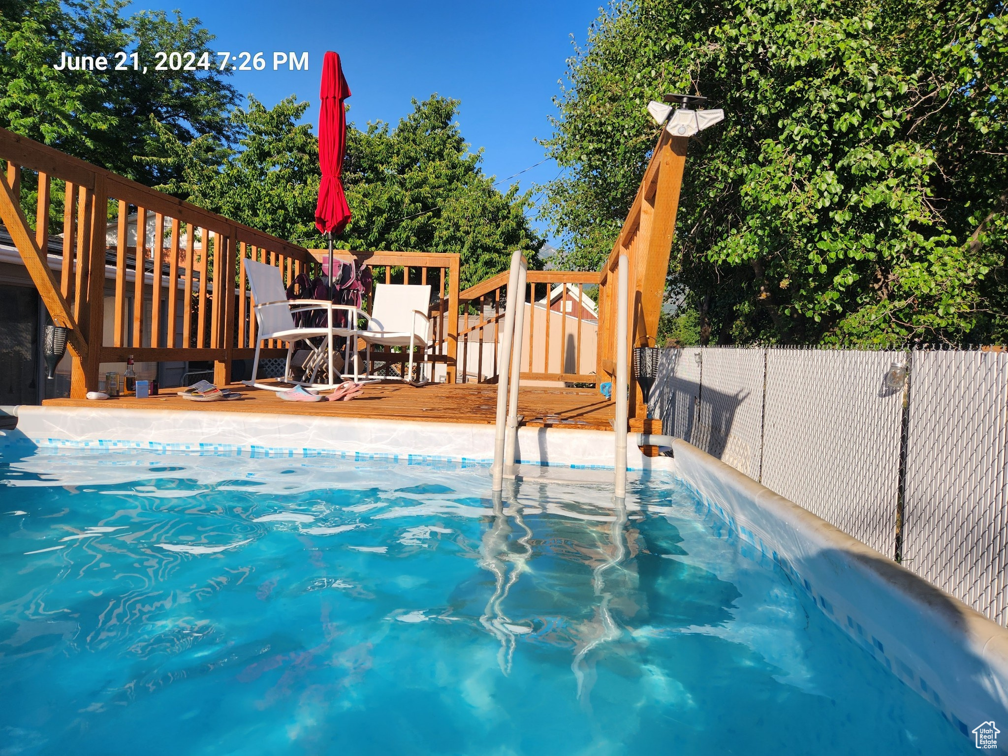 View of swimming pool with a deck