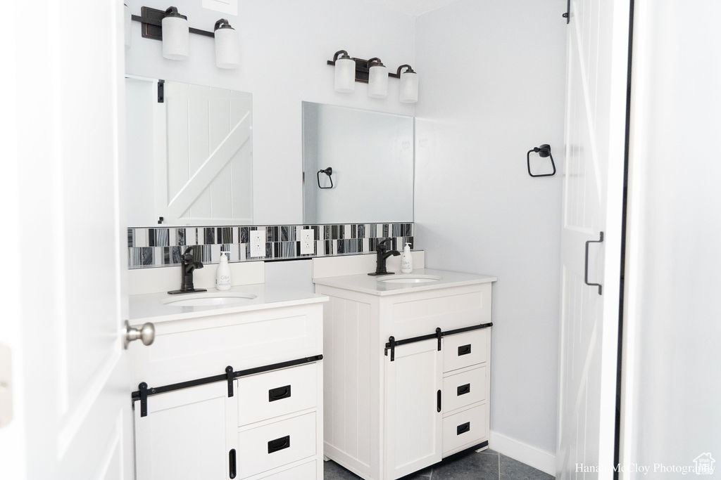 Bathroom featuring decorative backsplash and vanity