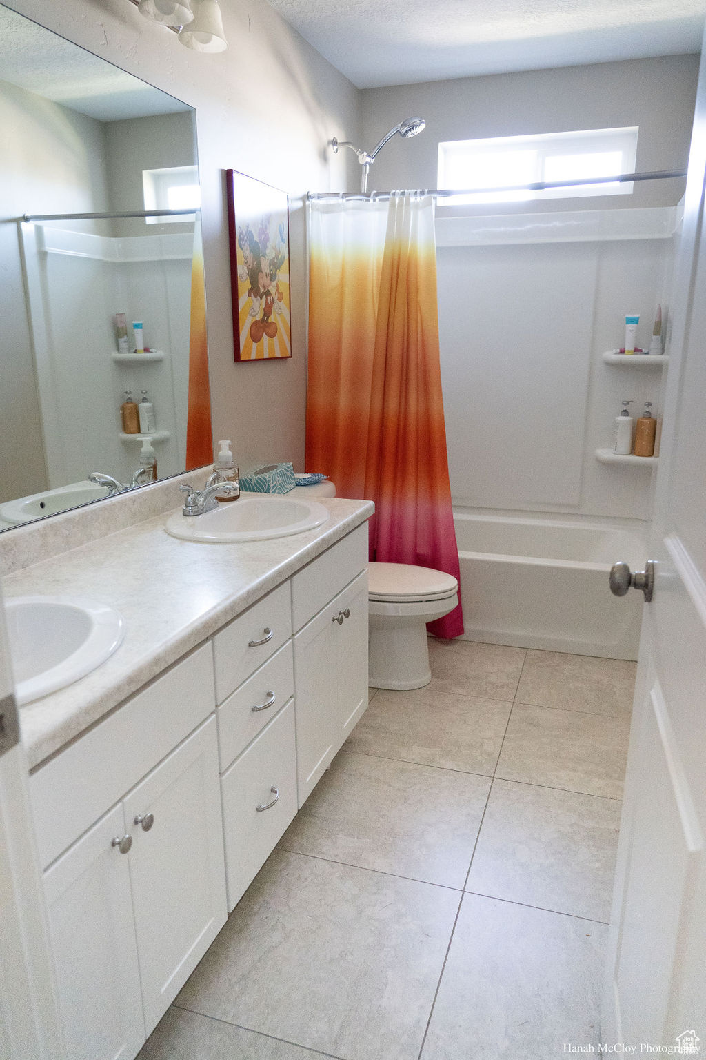 Full bathroom featuring vanity, tile patterned floors, toilet, a textured ceiling, and shower / tub combo