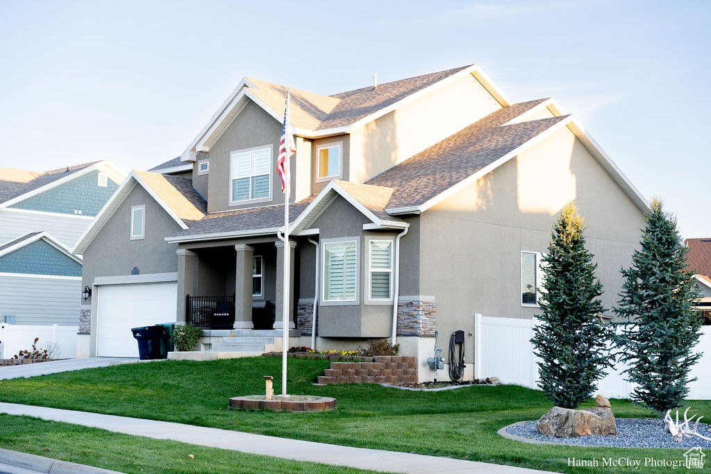 Craftsman-style home with a garage and a front lawn