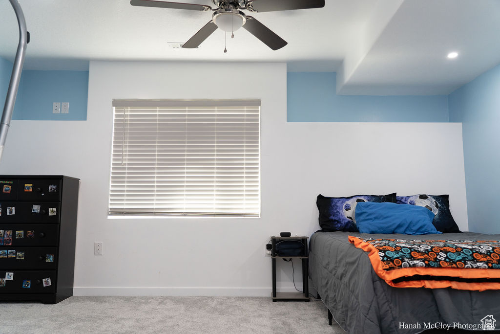 Carpeted bedroom with ceiling fan