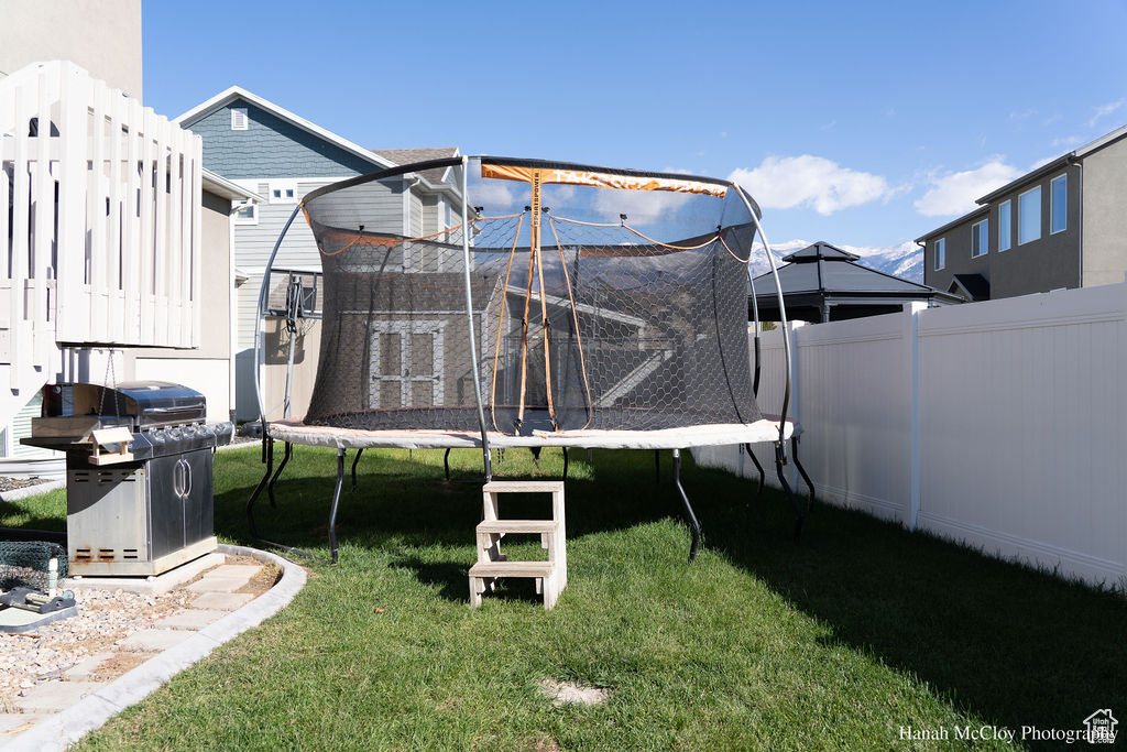 View of yard with a trampoline