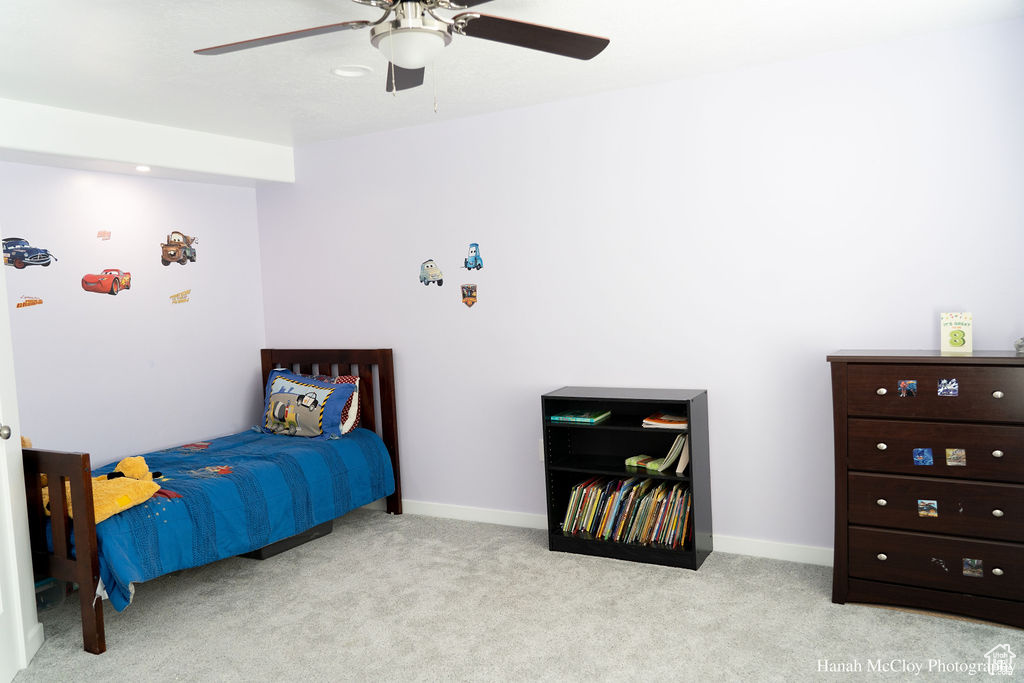 Carpeted bedroom with ceiling fan