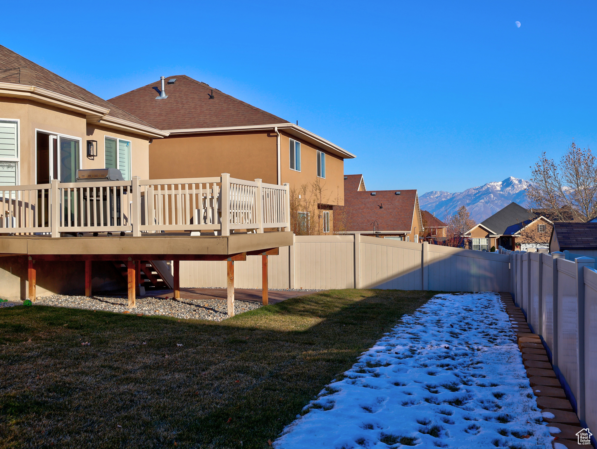 Rear view of property featuring a deck with mountain view and a yard