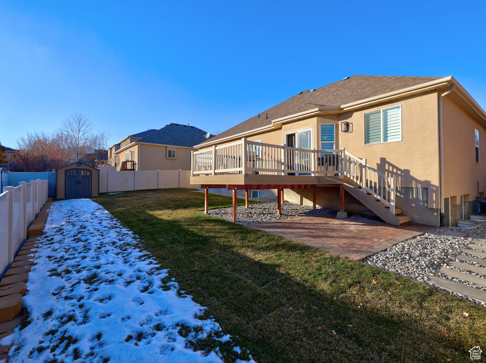 Rear view of property featuring a patio, a shed, a deck, and a lawn