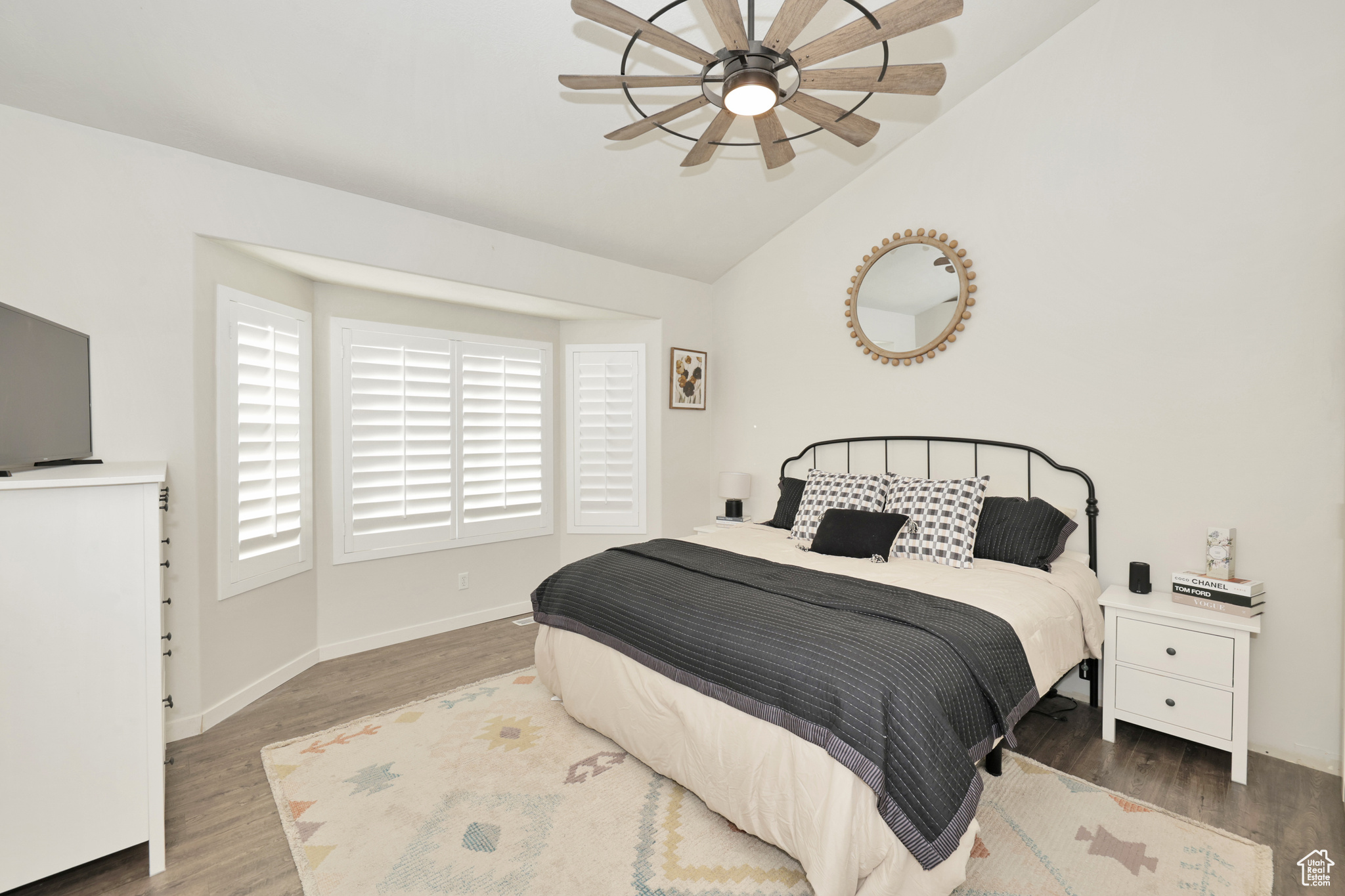 Bedroom with hardwood / wood-style flooring, vaulted ceiling, and ceiling fan