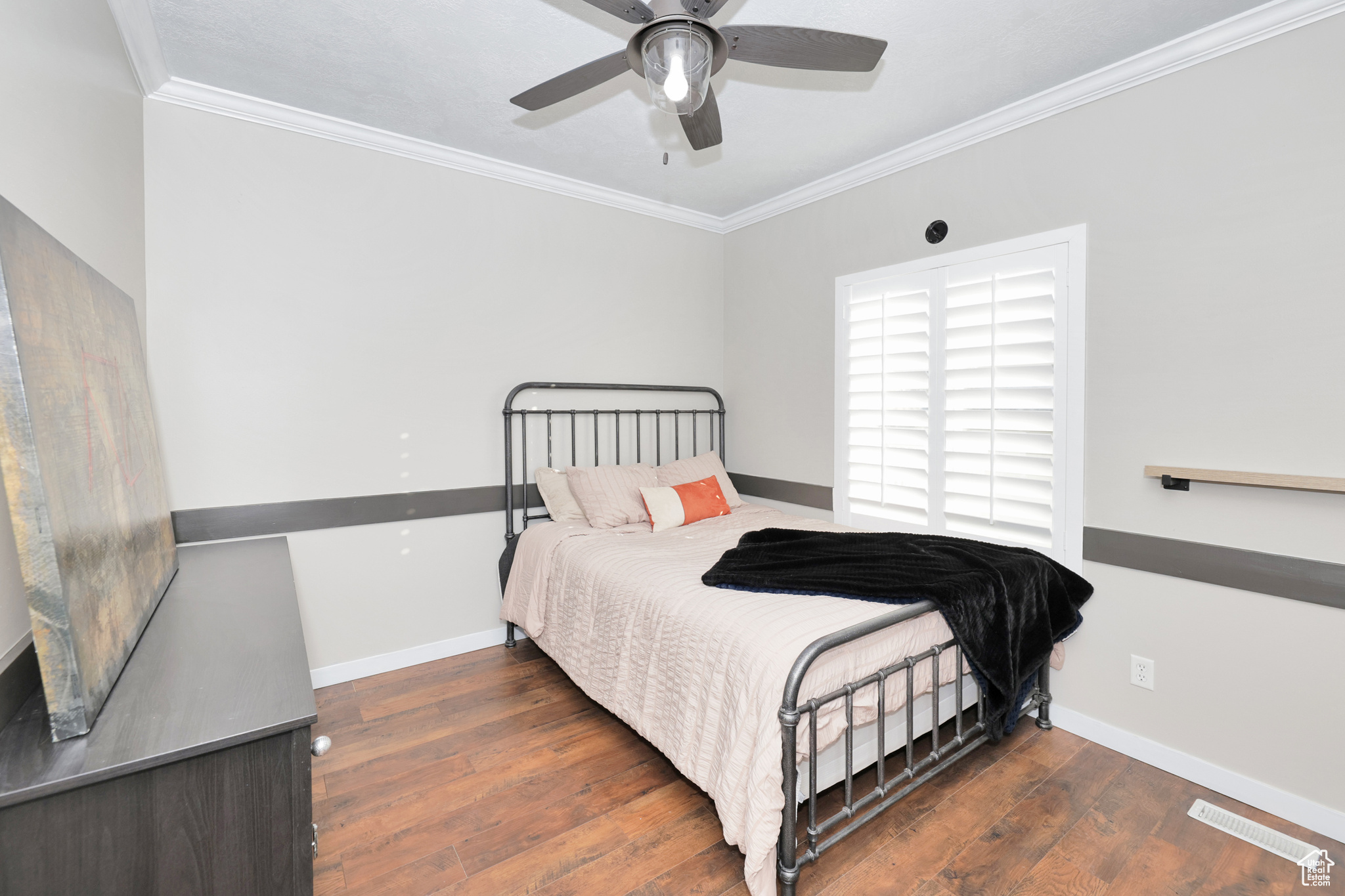 Bedroom with crown molding, ceiling fan, and dark wood-type flooring