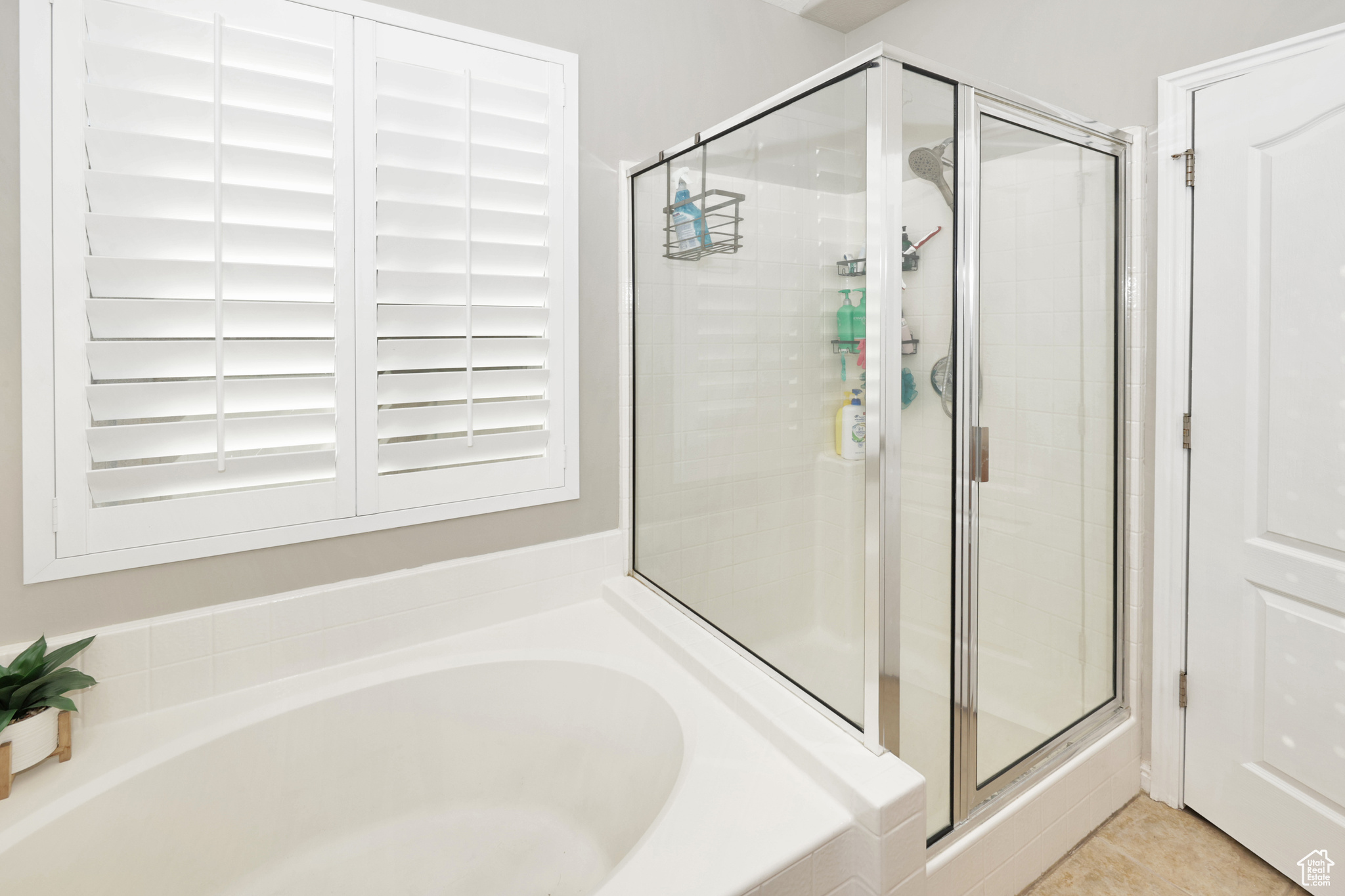 Bathroom with tile patterned floors and plus walk in shower