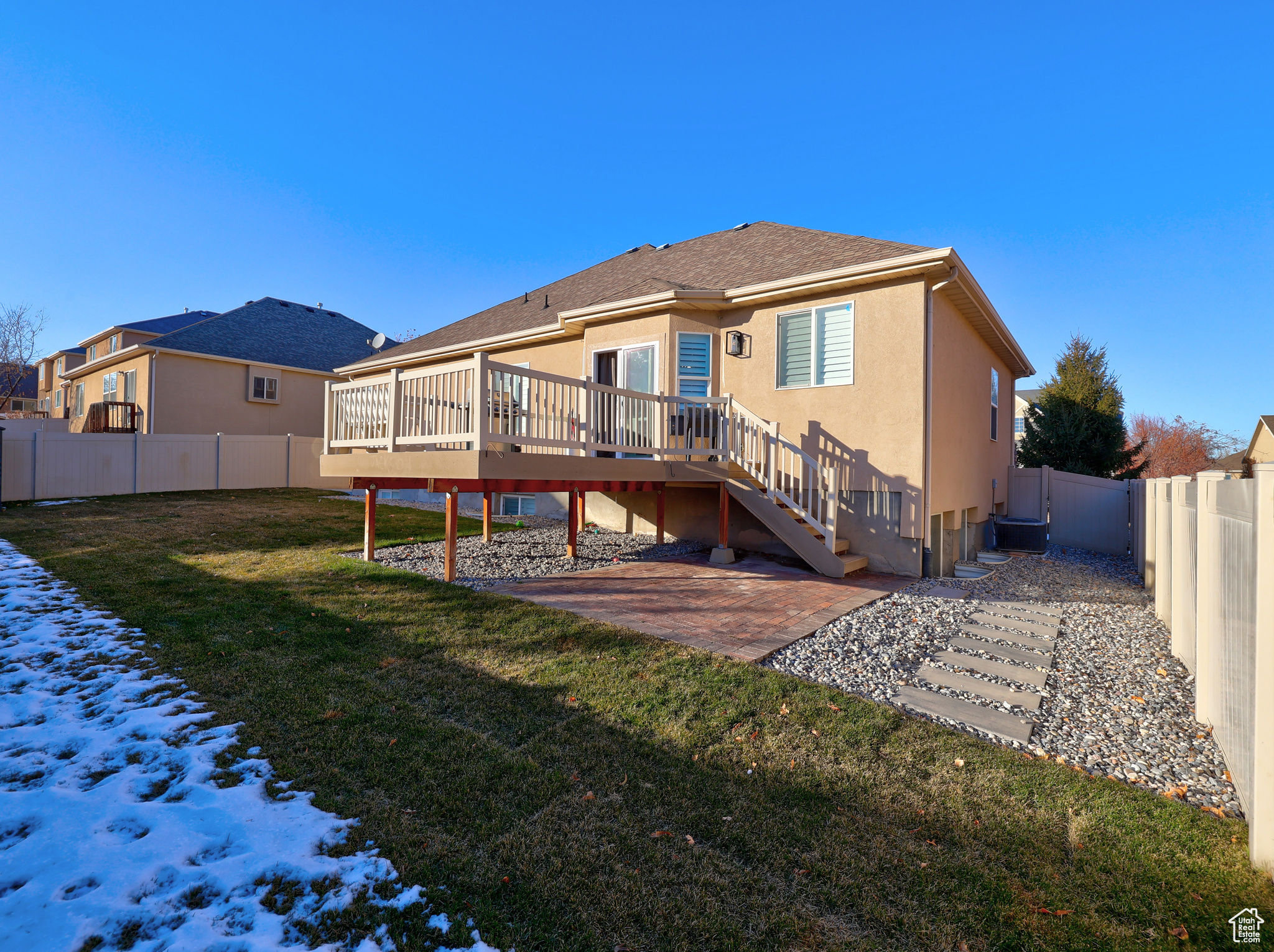 Rear view of house featuring a patio area, a deck, and a yard