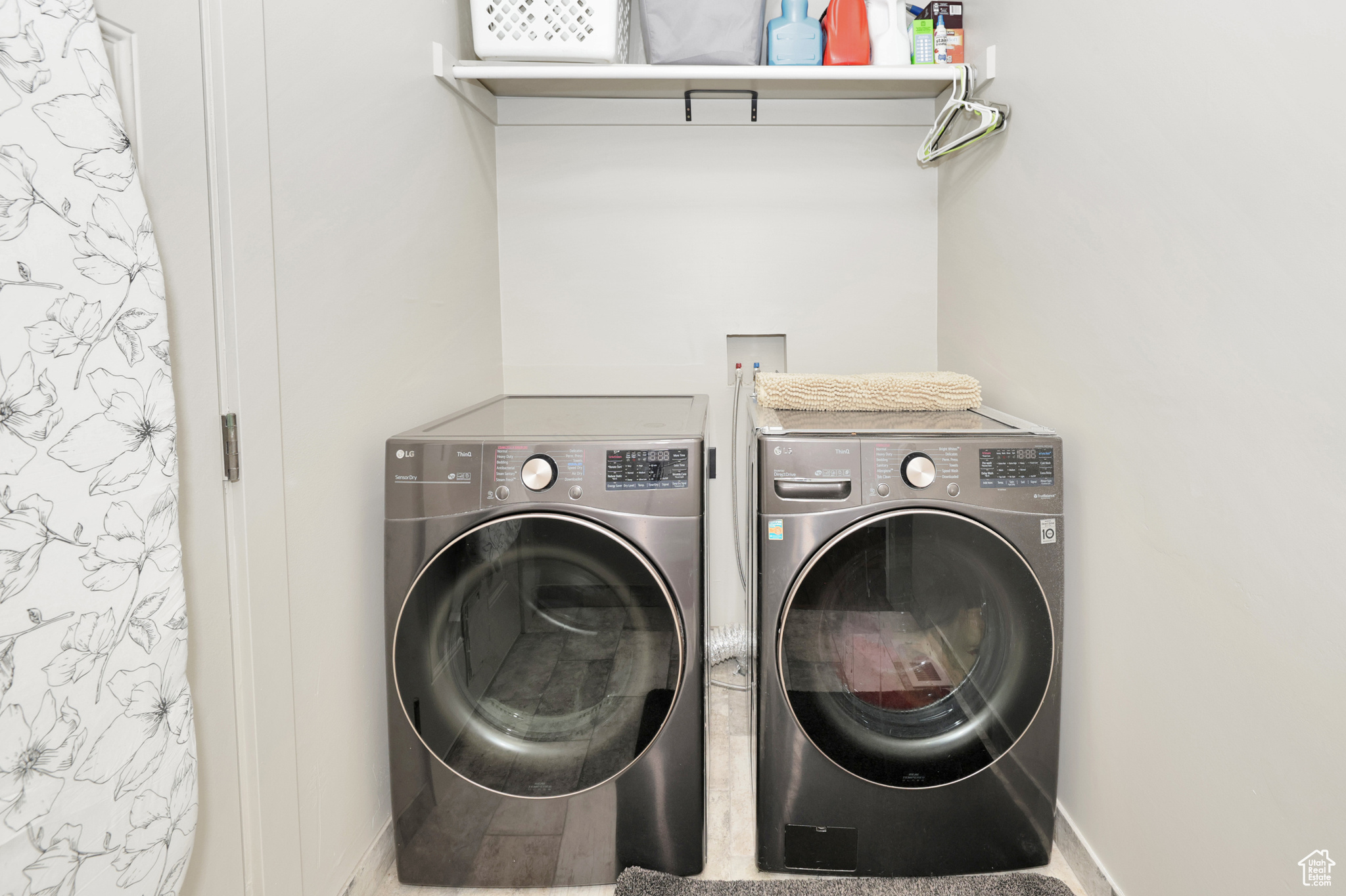 Laundry area with hardwood / wood-style flooring and washing machine and dryer