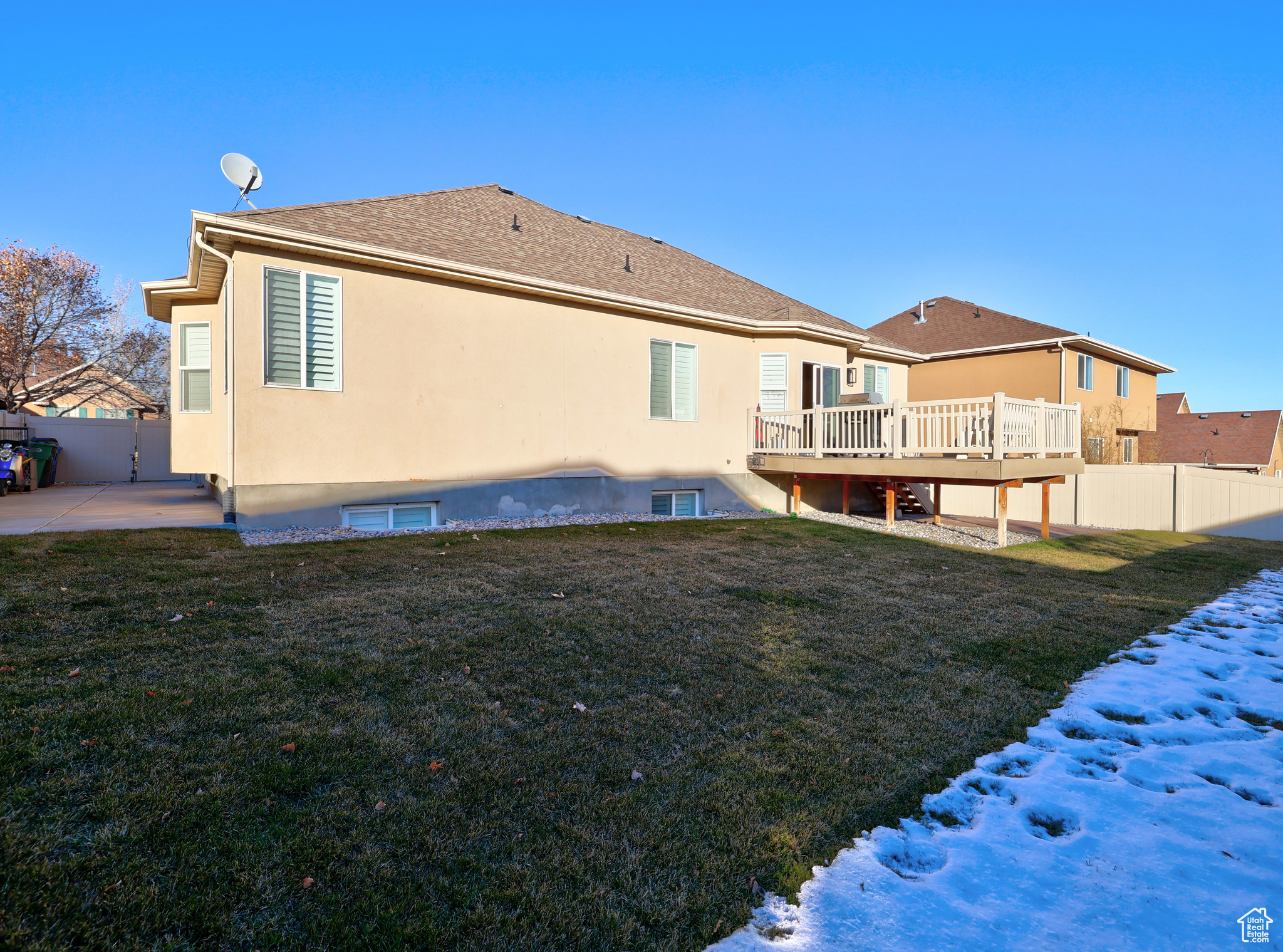 Back of house featuring a wooden deck and a yard