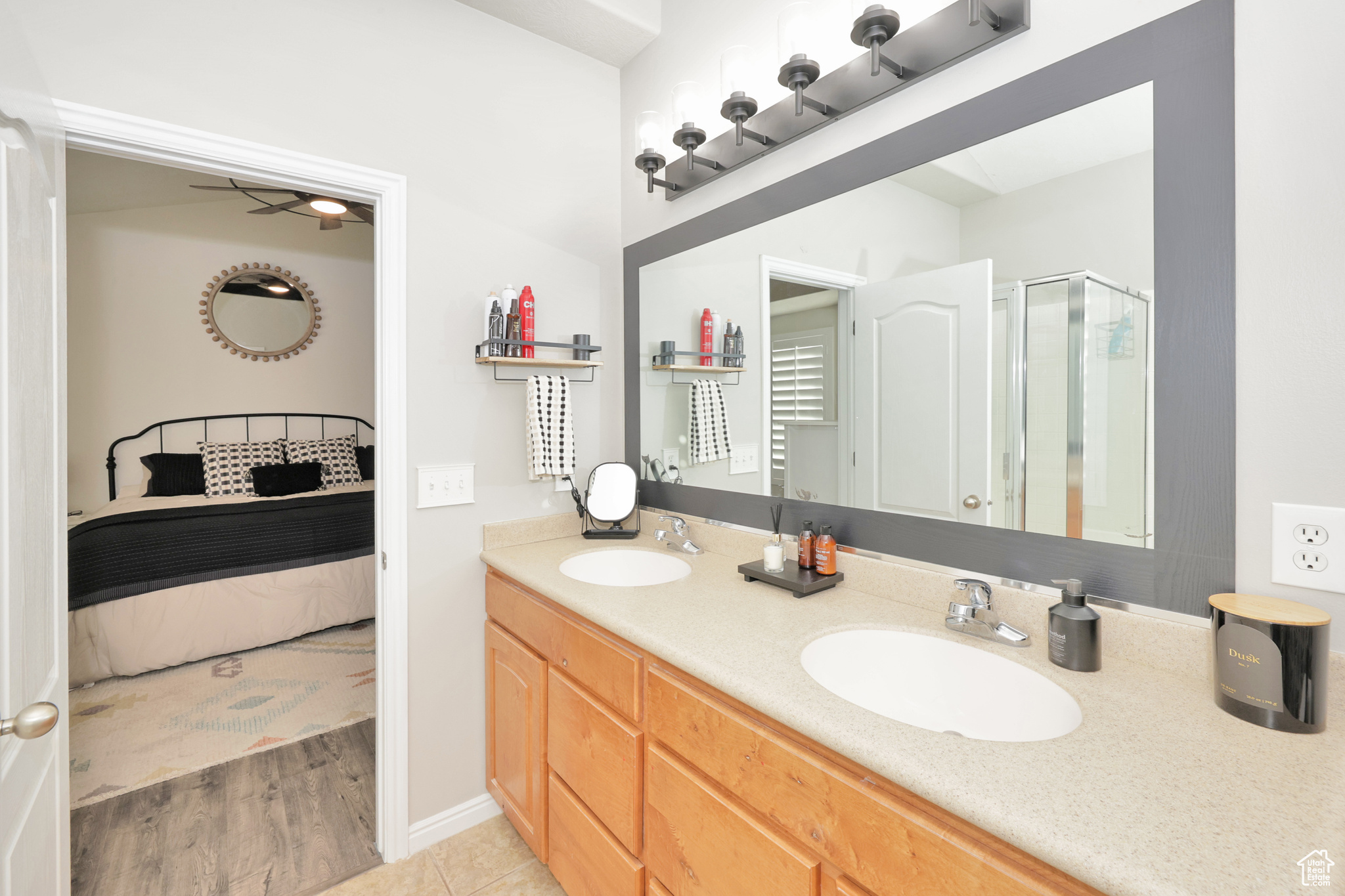 Bathroom with ceiling fan, vanity, an enclosed shower, and hardwood / wood-style flooring