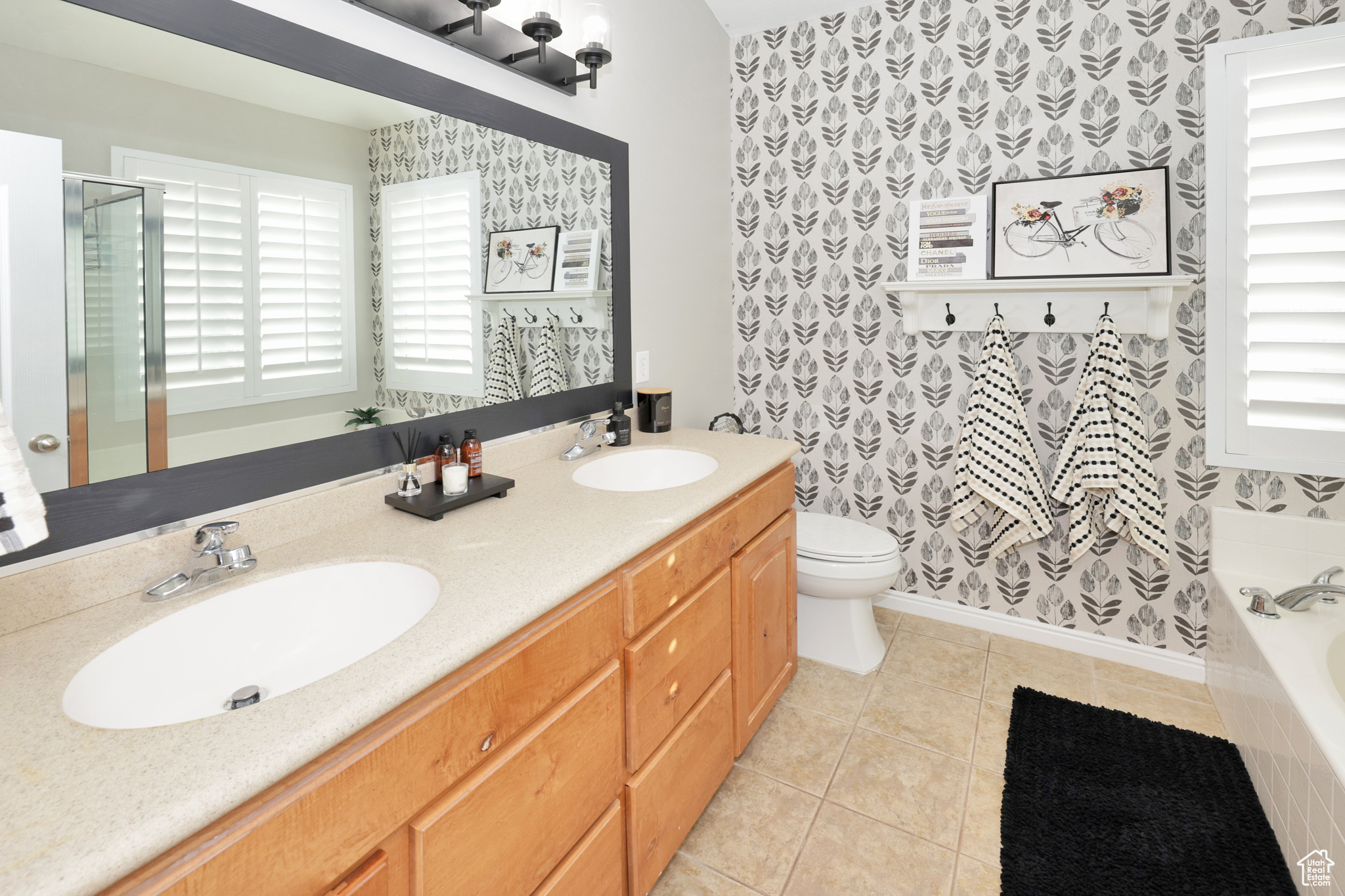 Full bathroom with tile patterned flooring, plenty of natural light, toilet, and vanity