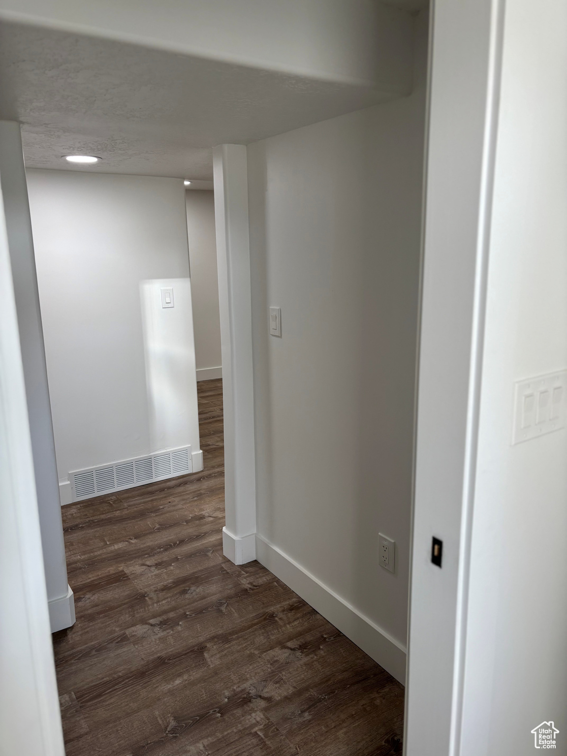 Hallway with dark wood-type flooring