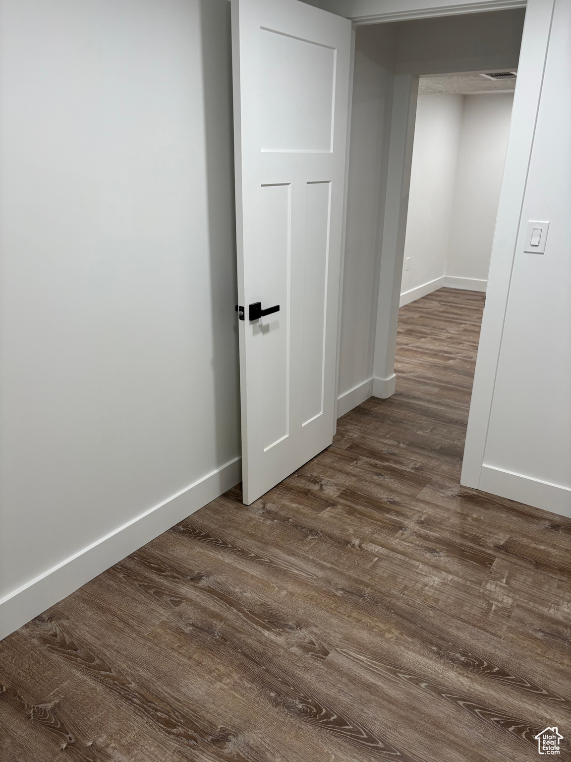 Interior space featuring dark wood-type flooring