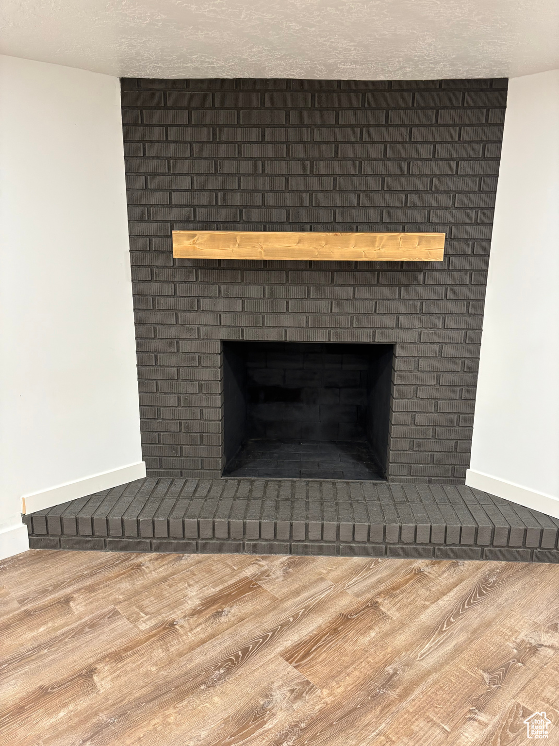 Details with hardwood / wood-style flooring, a fireplace, and a textured ceiling