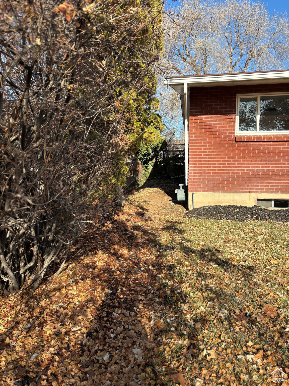 View of side of property featuring a lawn