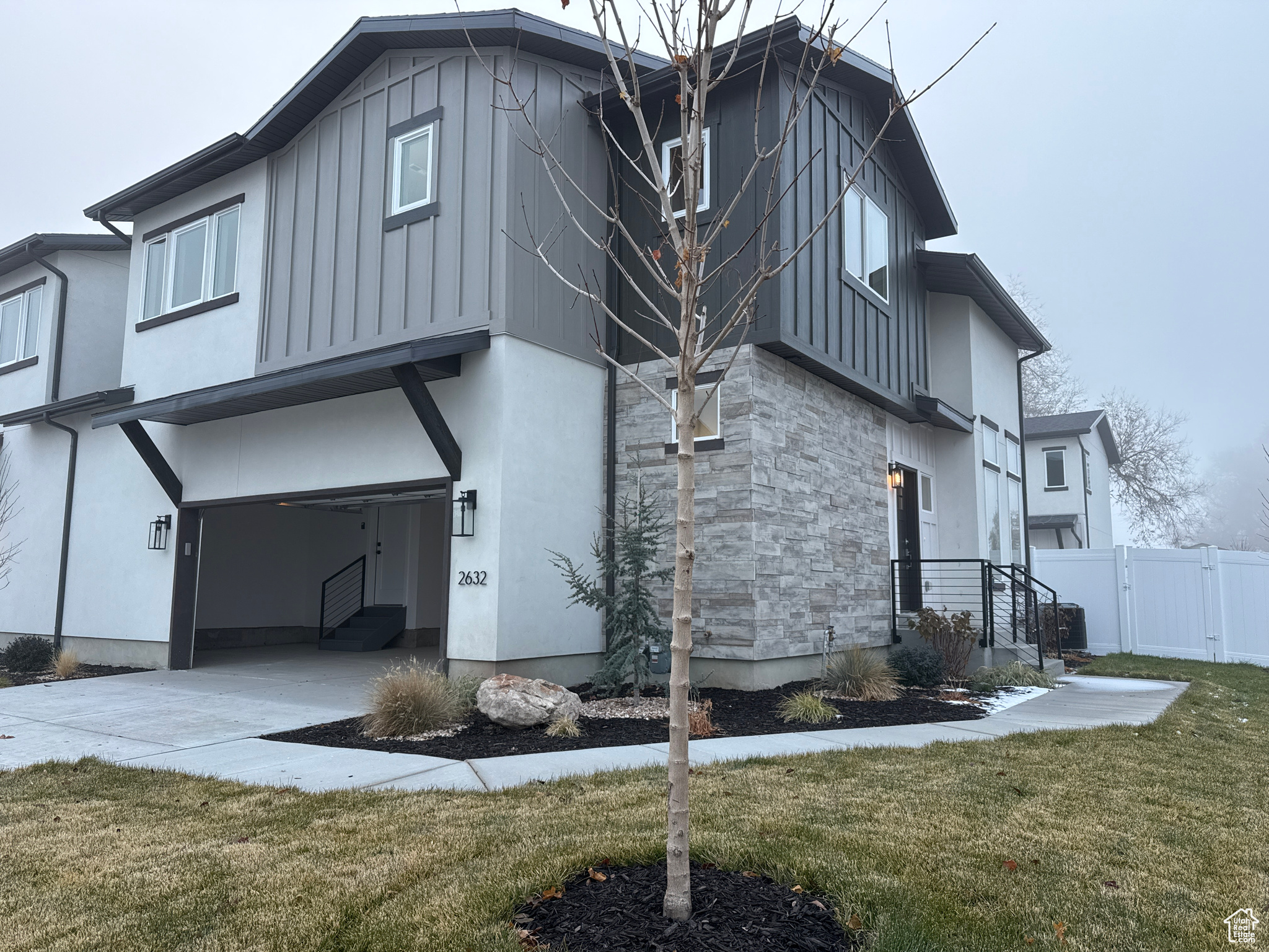 Exterior space featuring a lawn and a garage