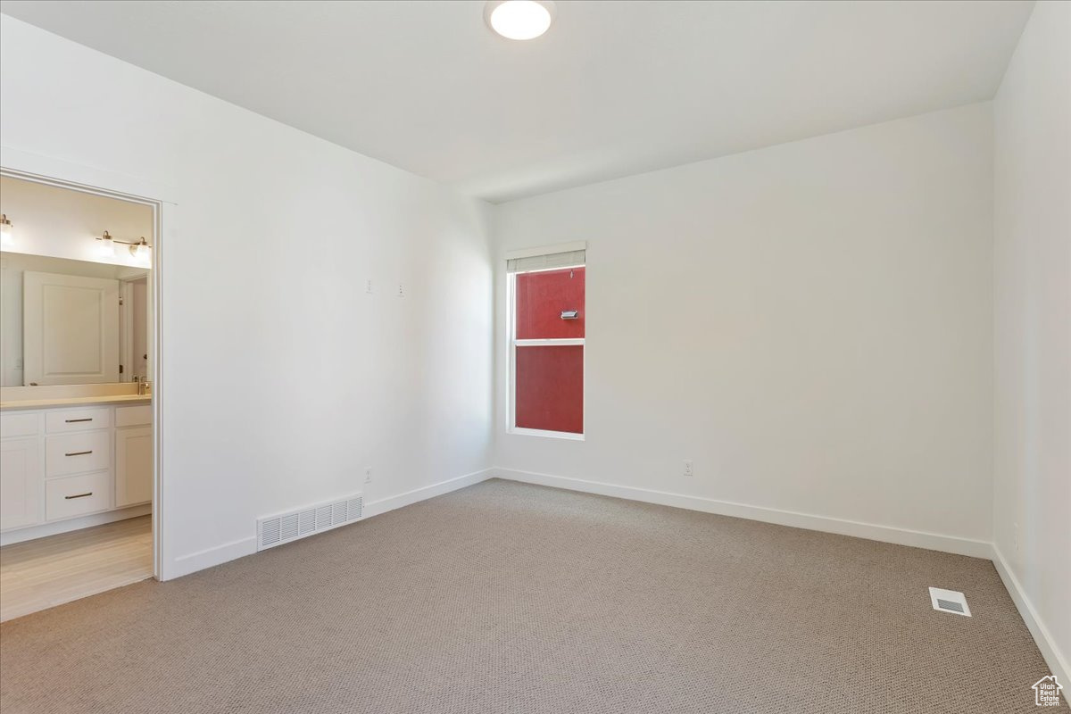 Unfurnished room with light carpet