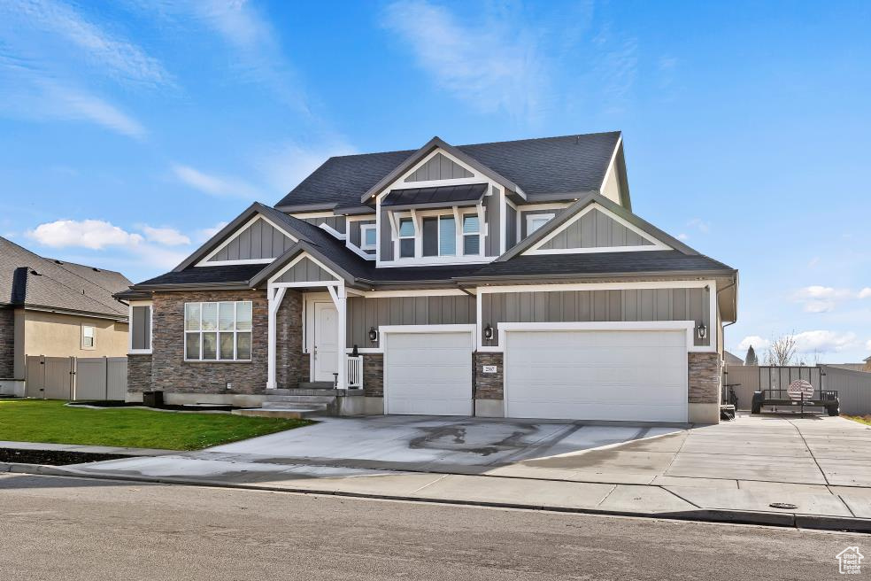 Exterior of home with large 4 car garage and paved RV pad