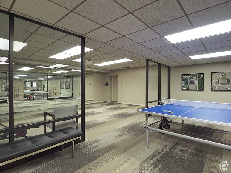 Playroom featuring hardwood / wood-style floors and a drop ceiling