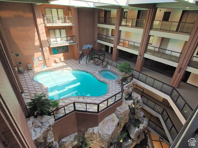 View of pool featuring an indoor hot tub and a patio