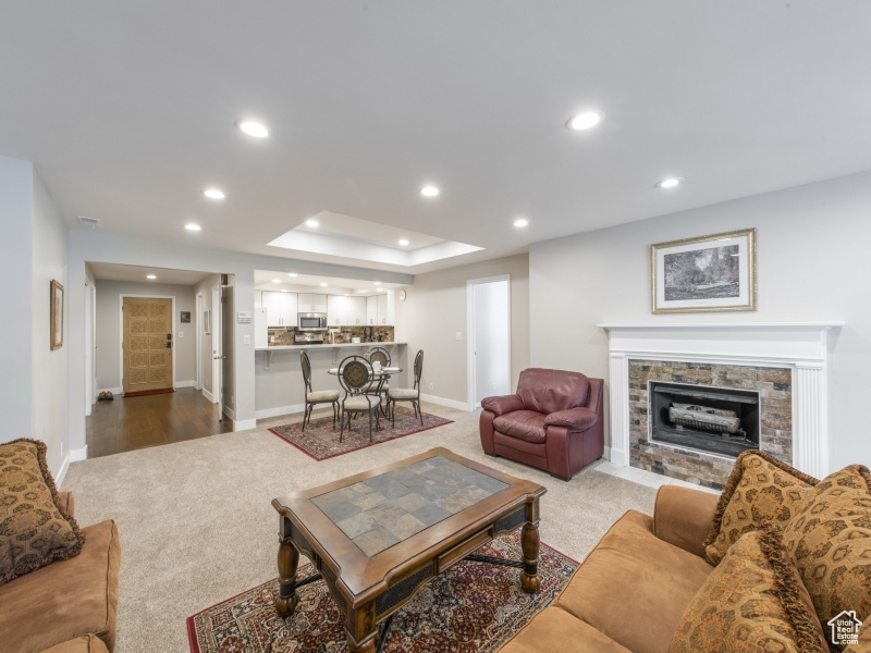 Living room featuring light carpet and a fireplace