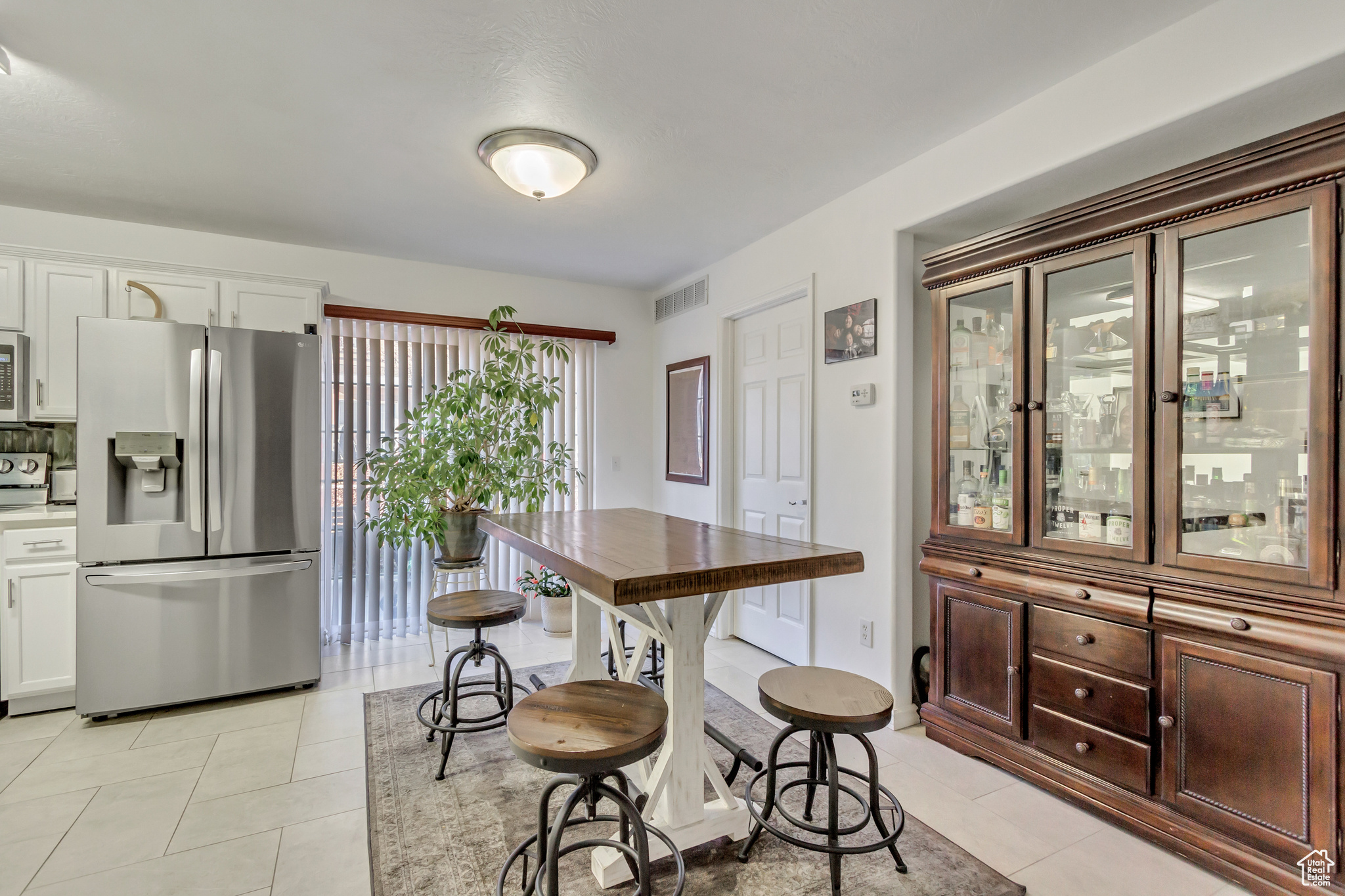 Dining space featuring light tile patterned floors