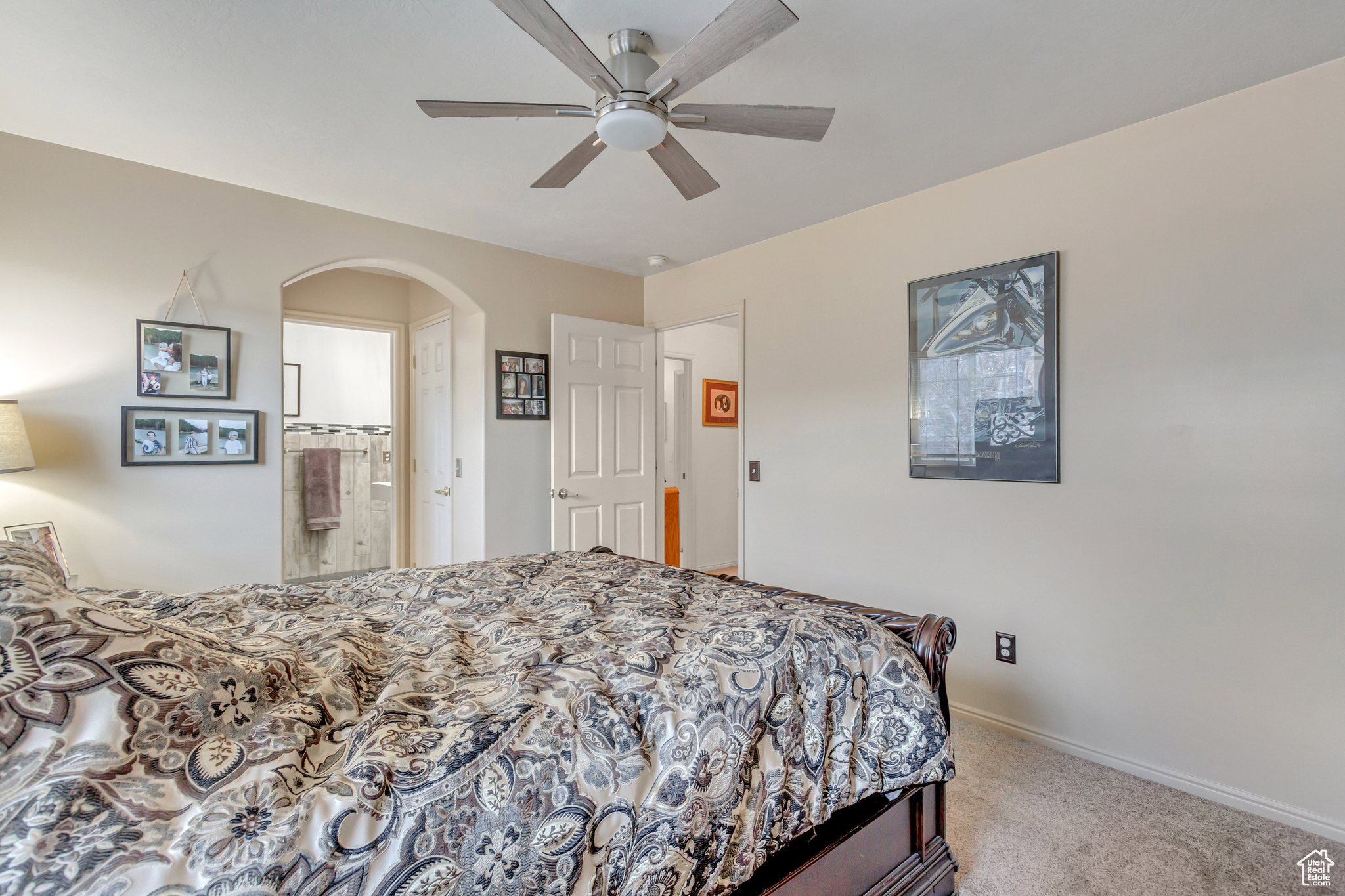 Bedroom with carpet, ceiling fan, and ensuite bath