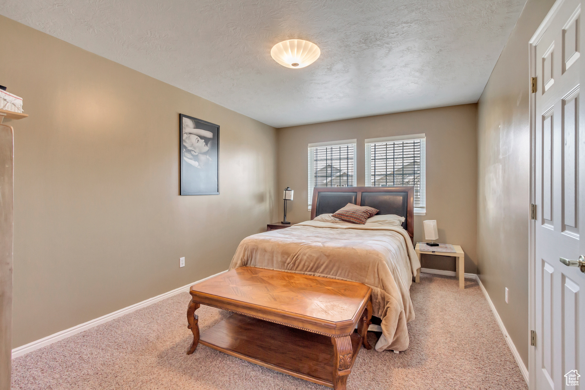 Bedroom with carpet floors and a textured ceiling