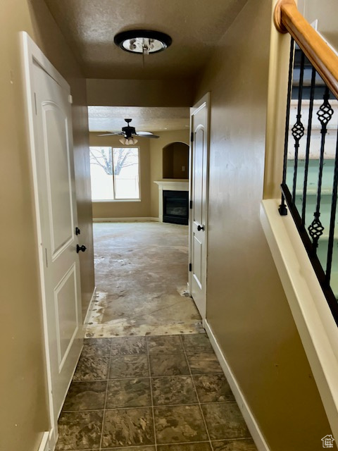 Hallway featuring a textured ceiling