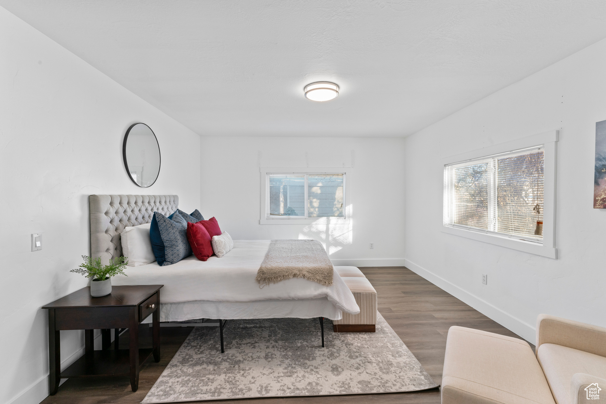 Bedroom with multiple windows and dark hardwood / wood-style floors