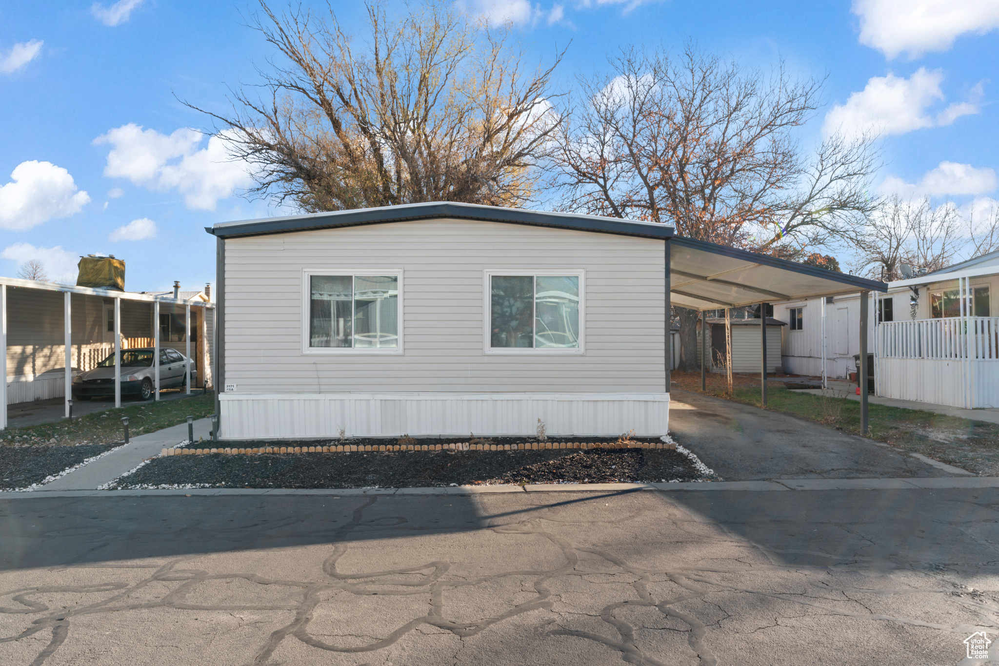 View of property exterior featuring a carport