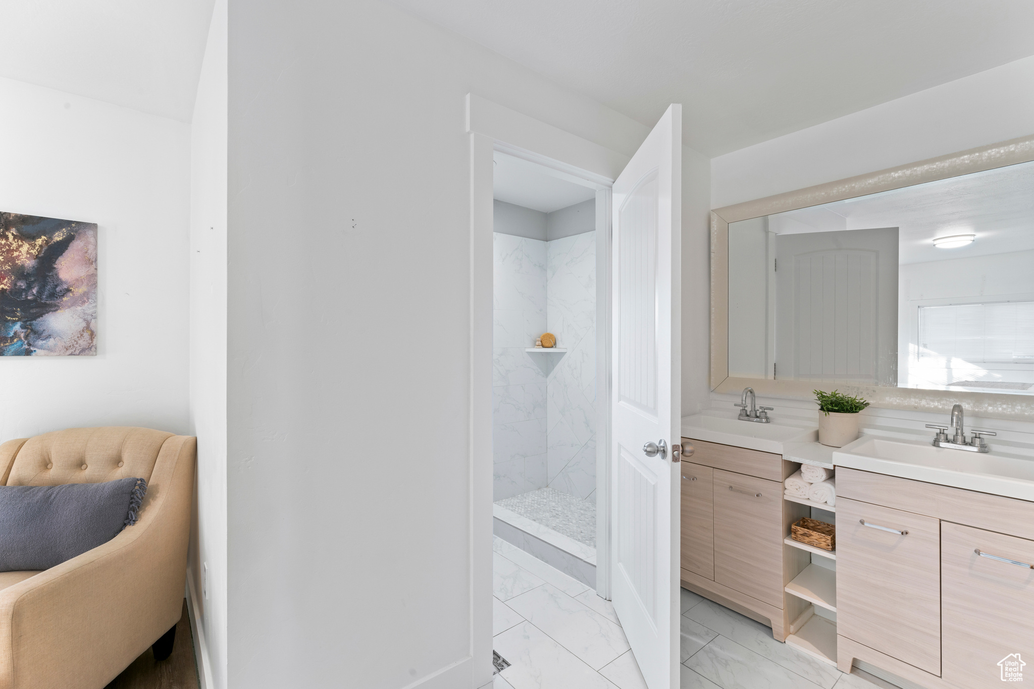 Bathroom featuring vanity and a tile shower