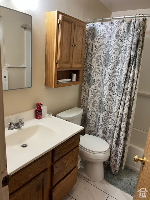 Full bathroom with vanity, toilet, and shower / bathtub combination with curtain