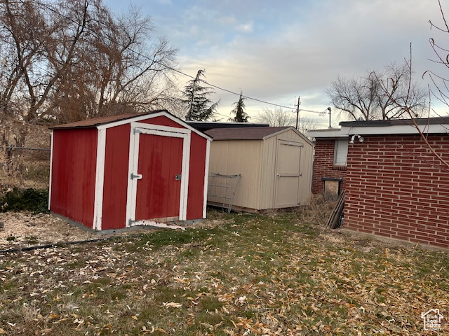 View of outdoor structure with a lawn