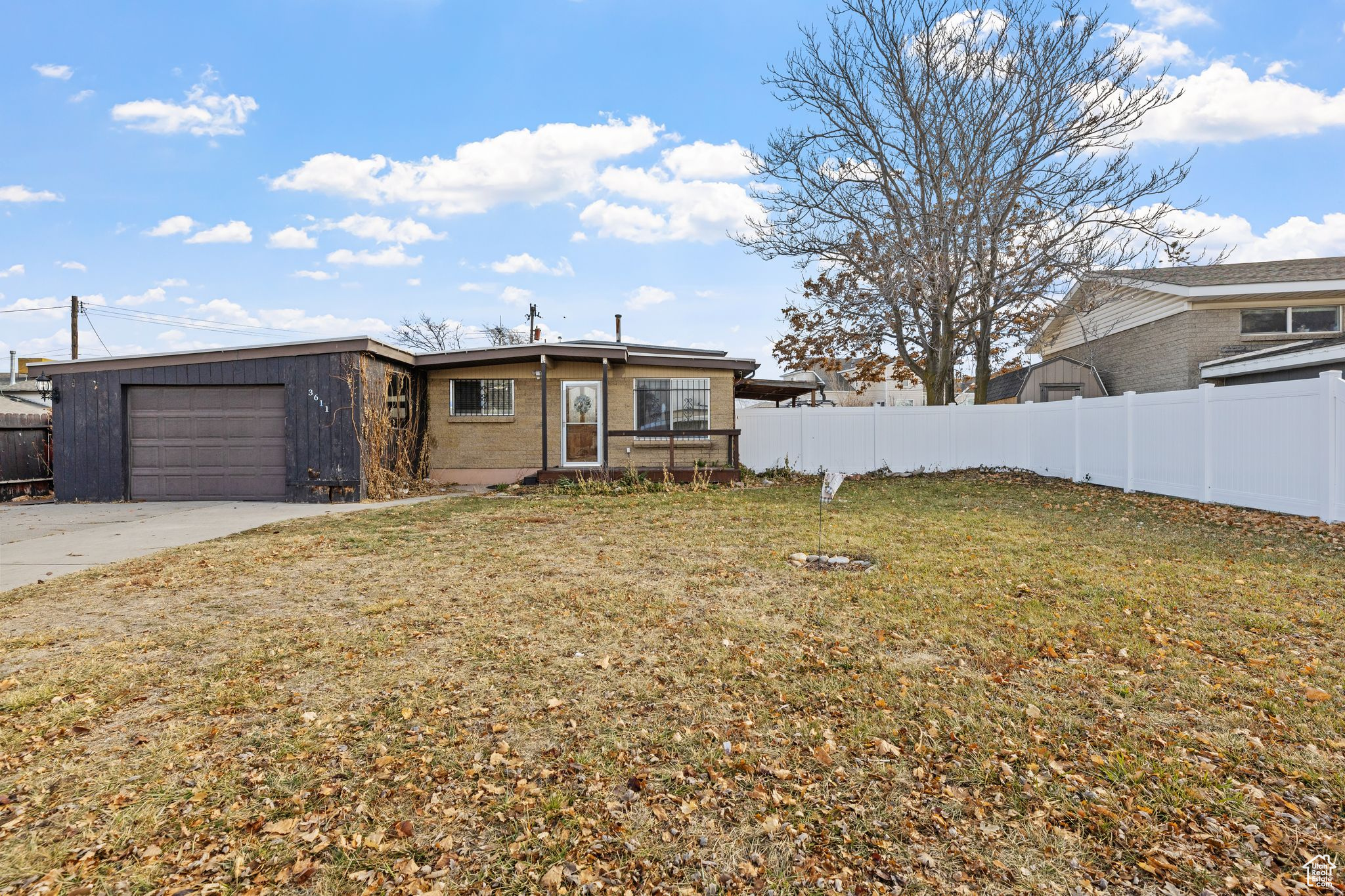 View of front of house featuring a front yard and a garage