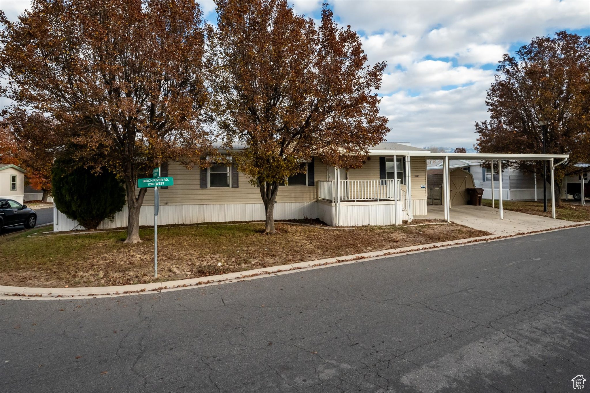 View of front of home featuring covered porch and a carport