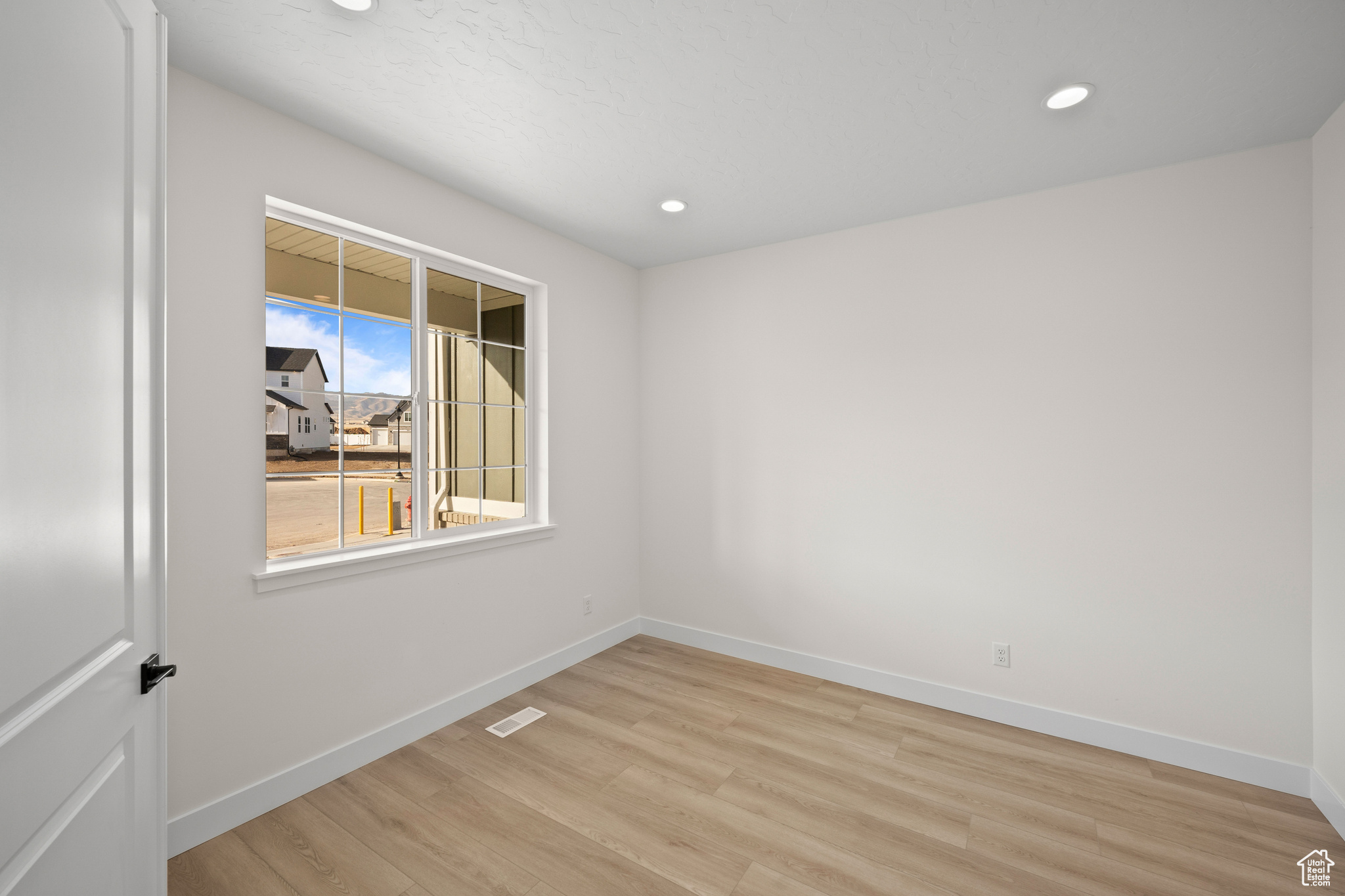 Spare room with light hardwood / wood-style floors