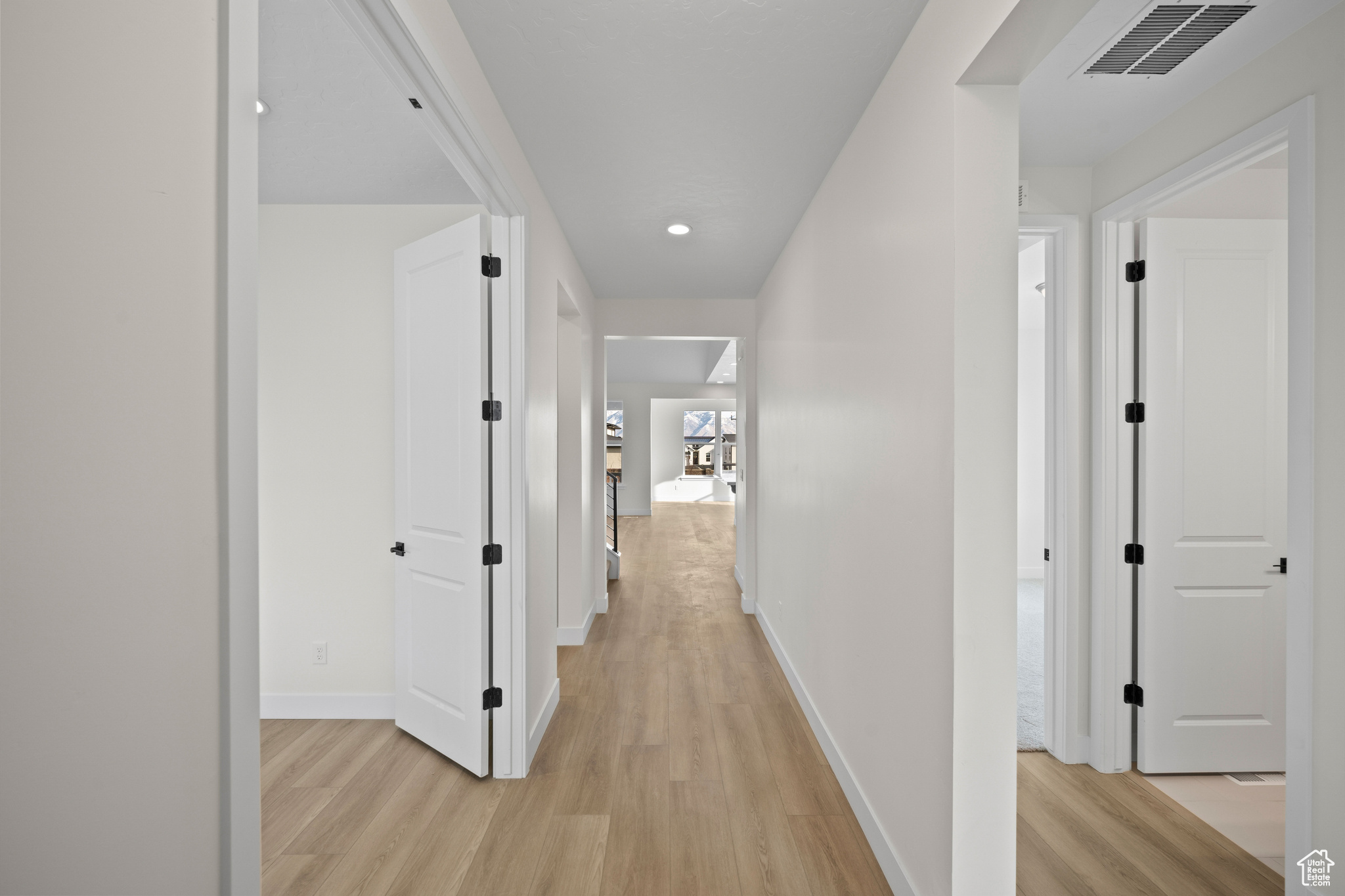 Corridor featuring light hardwood / wood-style flooring