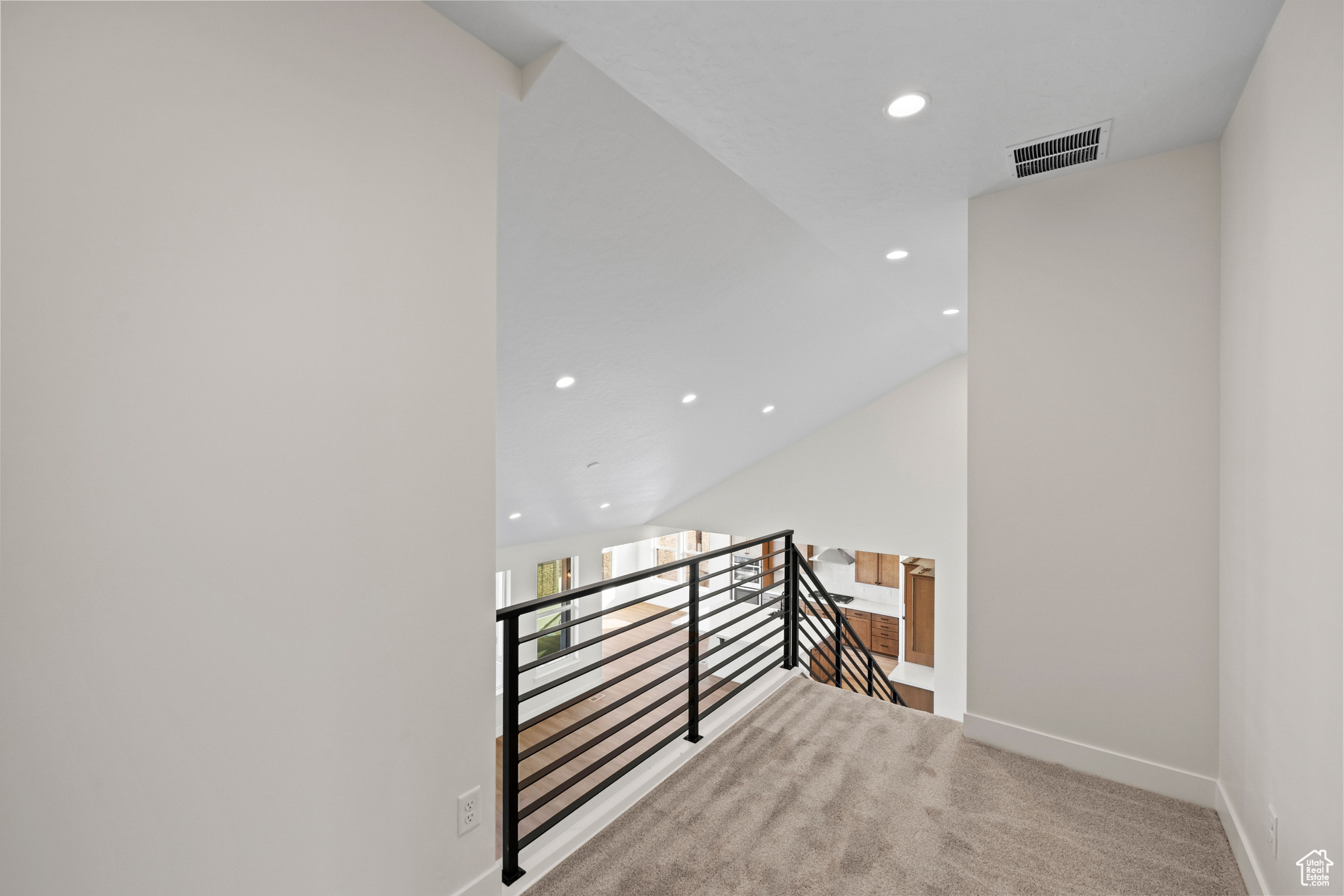 Stairway featuring carpet and vaulted ceiling