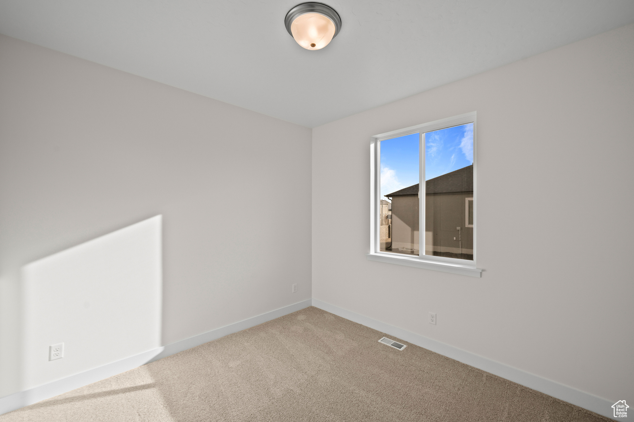 View of carpeted spare room